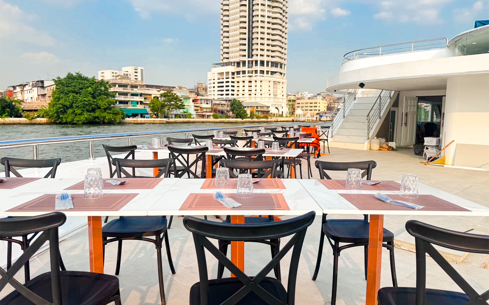 Luxury dinner cruise tables set on ICONSIAM riverboat, Bangkok, Thailand.