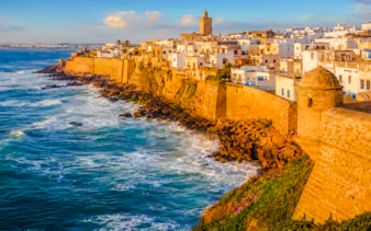 Essaouira coastal view with historic Medina walls and ocean waves.