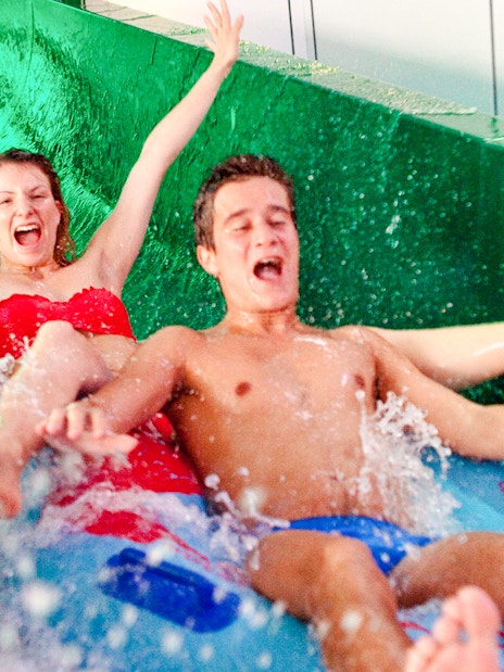 People enjoying a water slide at Aquaboulevard de Paris.