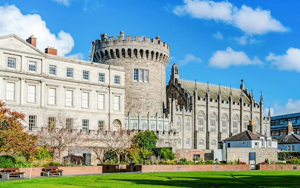Dublin Castle with its medieval tower and Gothic chapel under a blue sky.