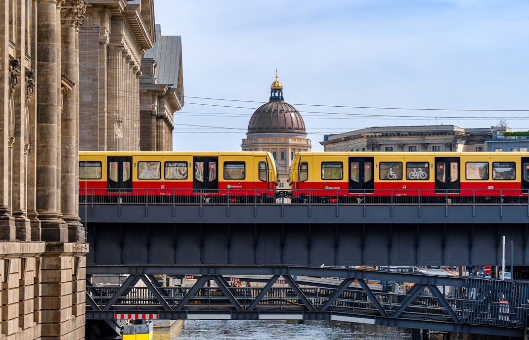 S-Bahn train crossing Museum Island bridge in Berlin, showcasing public transport.
