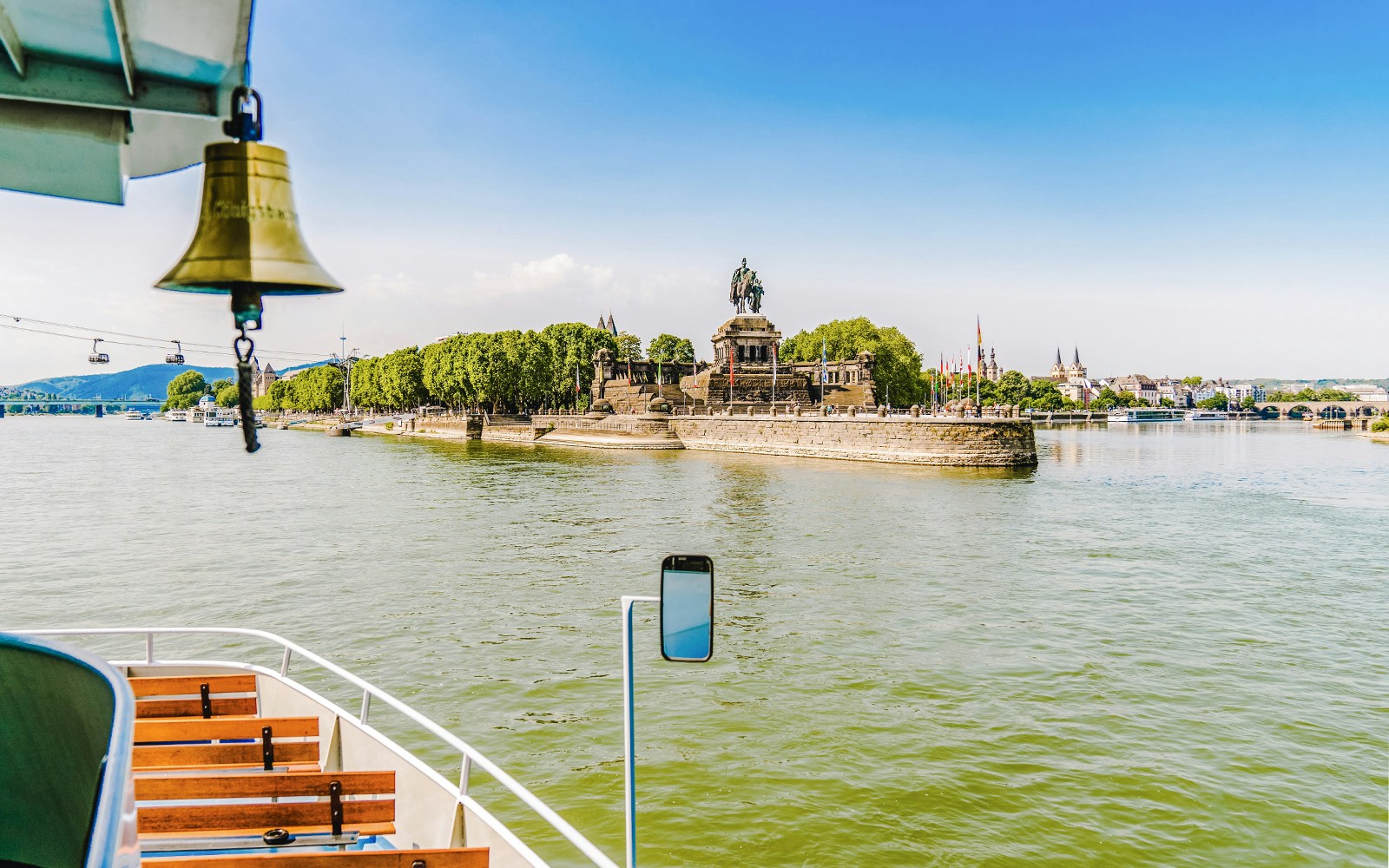 Koblenz sightseeing cruise passing Deutsches Eck monument at Rhine and Moselle confluence.