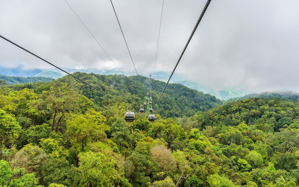 Cable car over lush forest at Sun World Ba Na Hills, Vietnam.