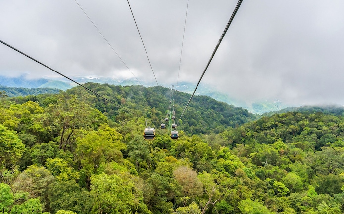 Cable car over lush forest at Sun World Ba Na Hills, Vietnam.