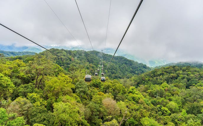 Cable car over lush forest at Sun World Ba Na Hills, Vietnam.