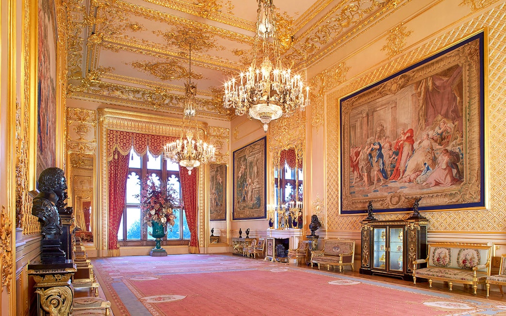 Windsor Castle's opulent room with chandeliers, ornate tapestries, and gilded decor.