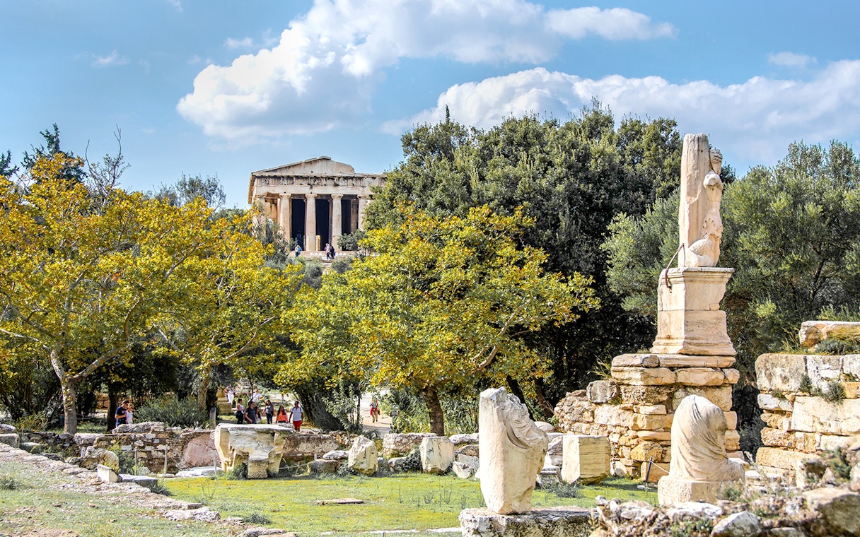 Ancient Agora of Athens with Temple of Hephaestus and marble ruins in foreground.