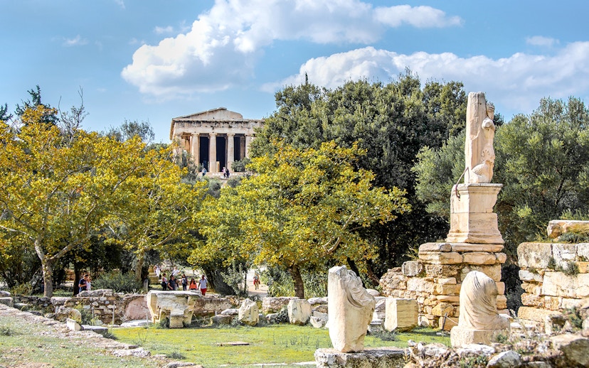 Ancient Agora of Athens with Temple of Hephaestus and marble ruins in foreground.