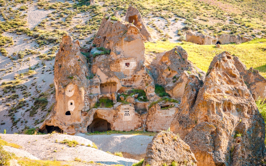 Uchisar Castle rock formations in Cappadocia, Turkey, with ancient carved dwellings.