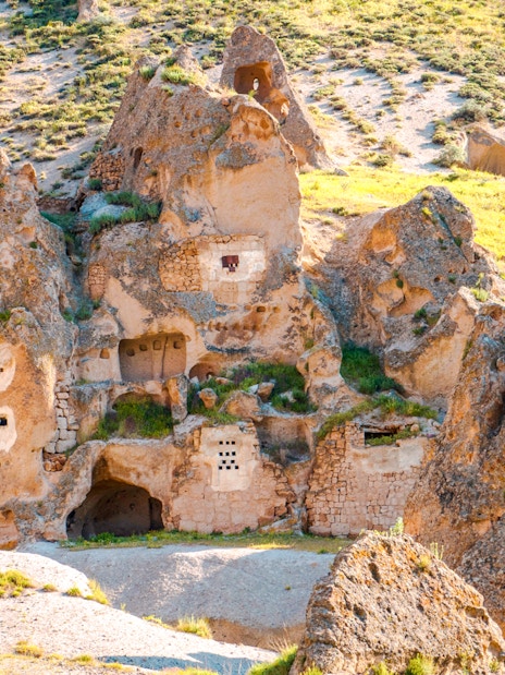 Uchisar Castle rock formations in Cappadocia, Turkey, with ancient carved dwellings.