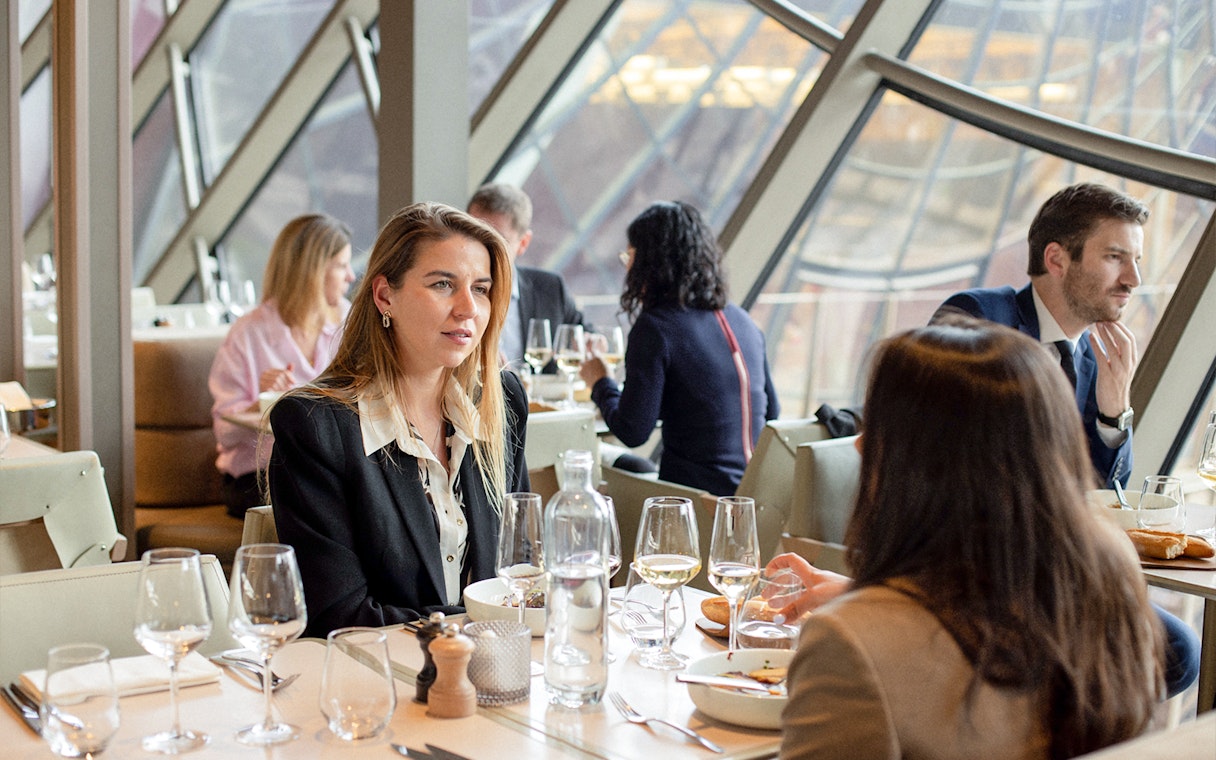 Lunch at Madame Brasserie, Eiffel Tower, with diners enjoying a meal and view.