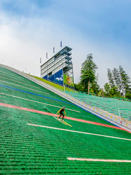 Ski jumper descending Bergisel ski jump in Innsbruck, Austria.