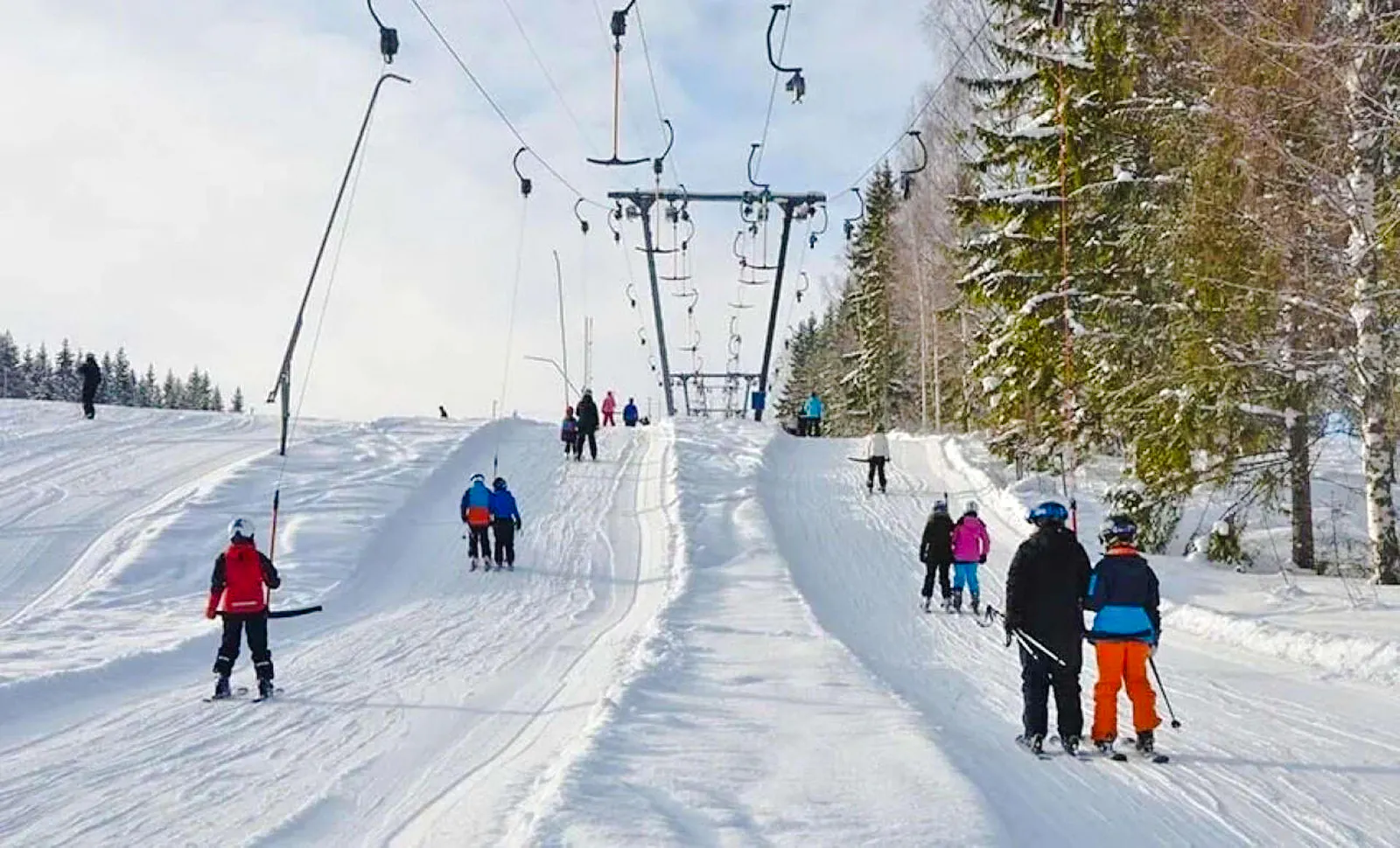 Skiers on a snowy slope using a cable car lift in Bursa, Turkey.