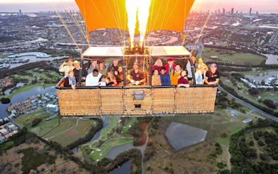 Hot air balloon ride over Gold Coast with views of Sirromet Winery and city skyline.
