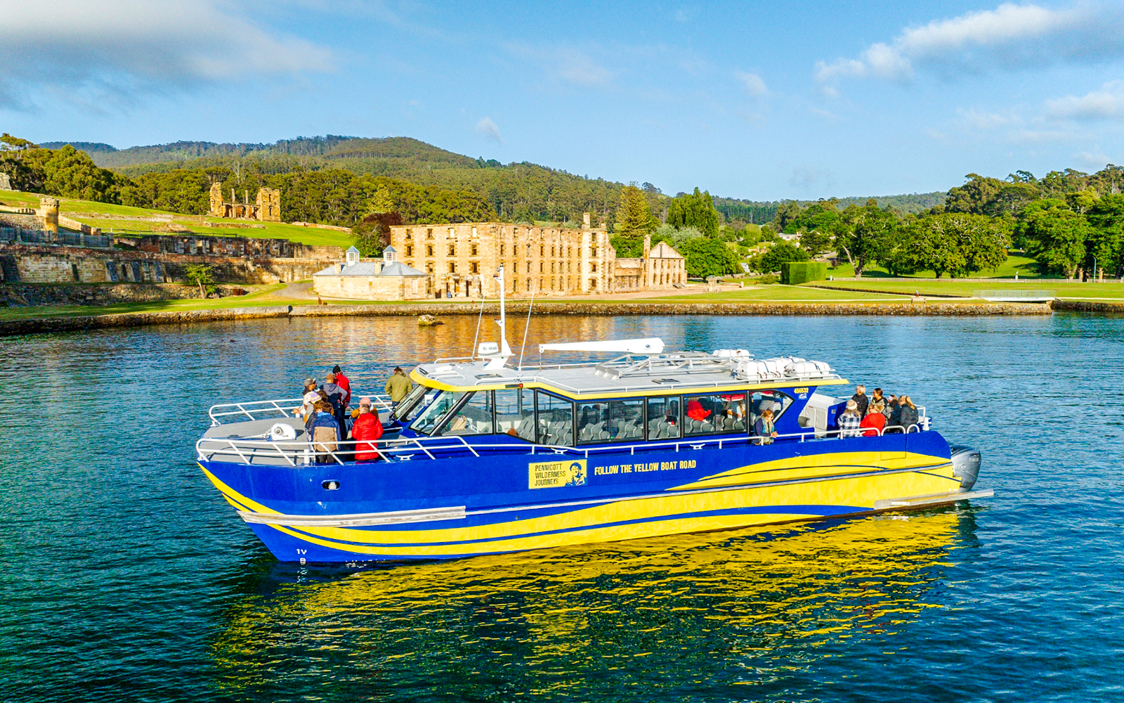 Cruise boat near historic site on Cape Raoul wilderness cruise, Hobart, Tasmania.