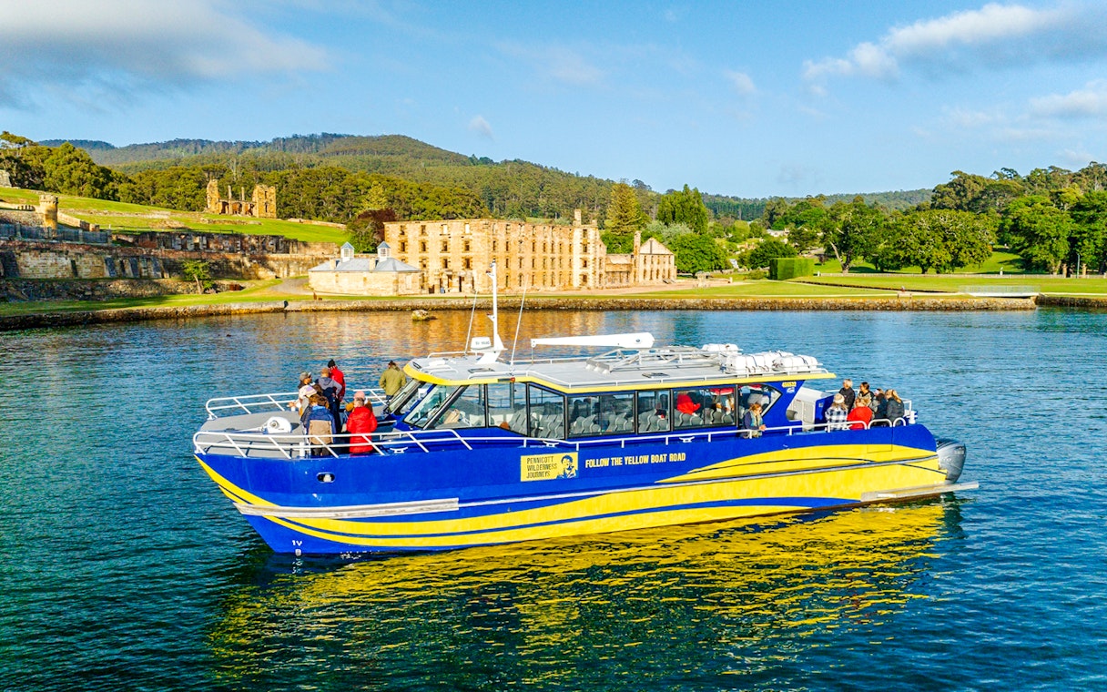 Cruise boat near historic site on Cape Raoul wilderness cruise, Hobart, Tasmania.