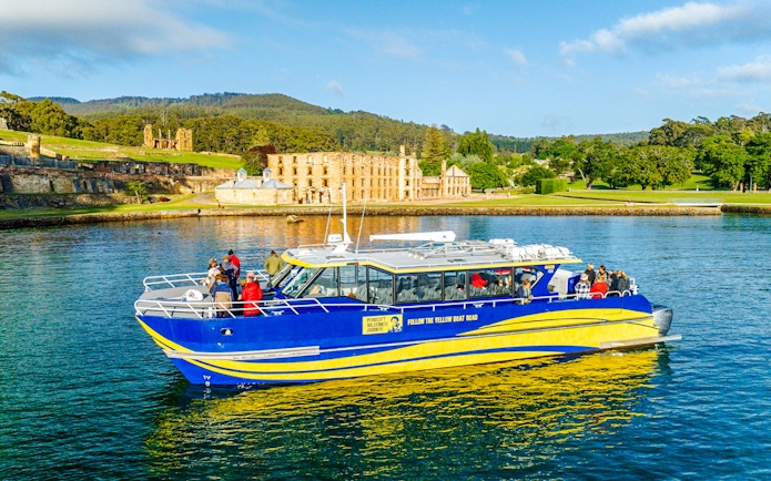 Cruise boat near historic site on Cape Raoul wilderness cruise, Hobart, Tasmania.