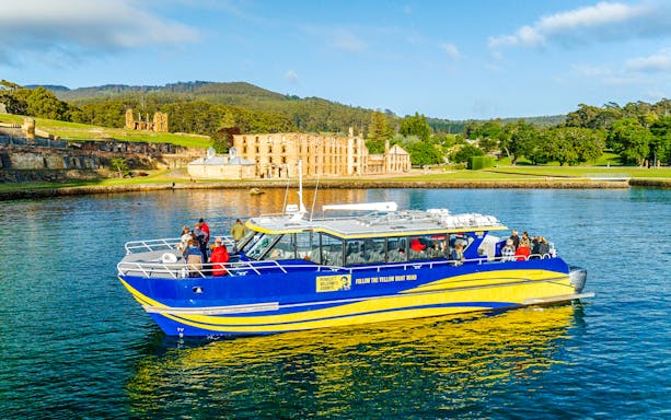 Cruise boat near historic site on Cape Raoul wilderness cruise, Hobart, Tasmania.