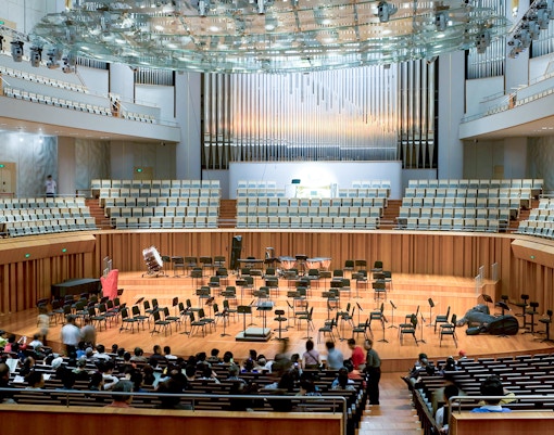 Concert hall interior with empty stage and audience seating for Barcelona Jazz Festival.