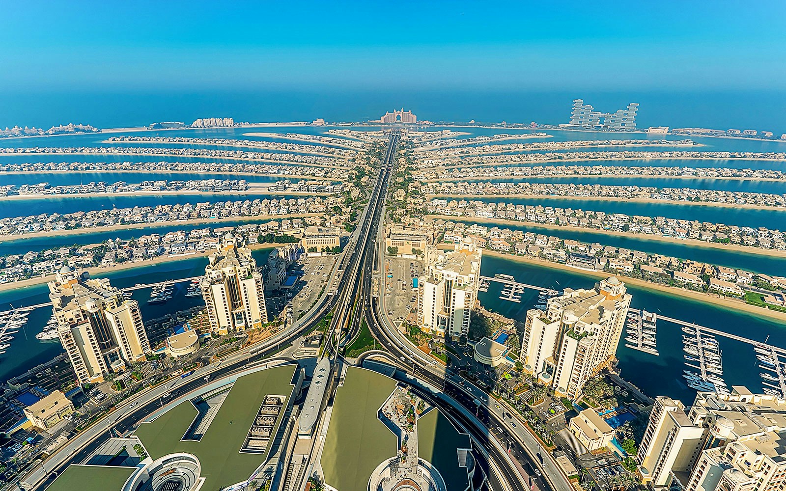 Aerial view of Palm Jumeirah in Dubai at sunrise, showcasing the iconic palm-shaped islands.