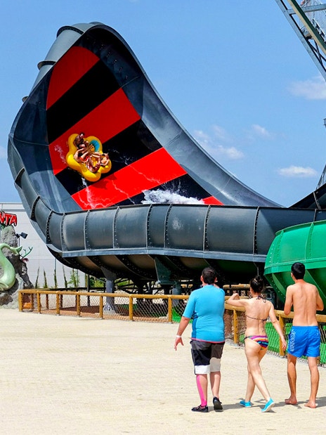 Visitors approach Aquaman Black Manta water slide at Parque Warner, Madrid.