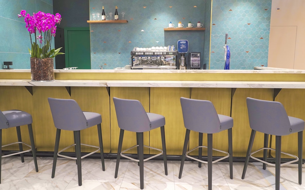 Bar area with seating at Plaza Premium First Lounge, Rome Fiumicino Airport Terminal 1.