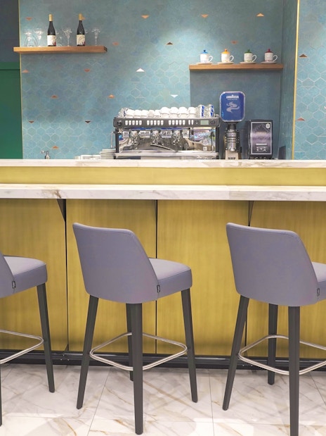 Bar area with seating at Plaza Premium First Lounge, Rome Fiumicino Airport Terminal 1.