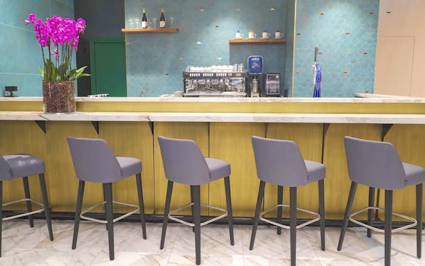 Bar area with seating at Plaza Premium First Lounge, Rome Fiumicino Airport Terminal 1.
