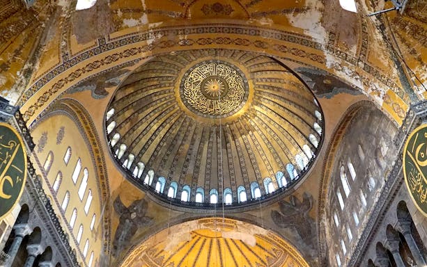 Hagia Sophia Museum dome interior with intricate mosaics and Arabic calligraphy, Istanbul.