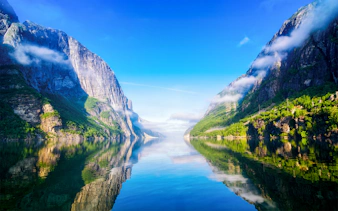Lysefjord in Norway with steep cliffs and calm reflective waters.