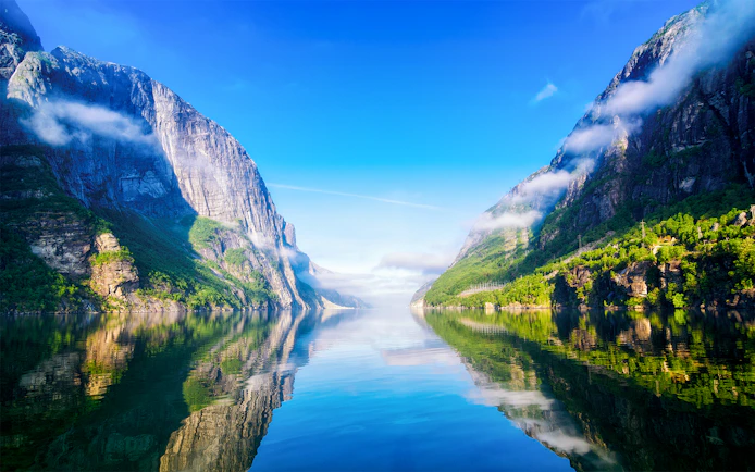 Lysefjord in Norway with steep cliffs and calm reflective waters.