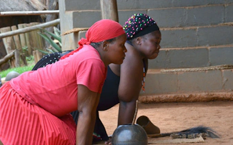 Women participating in a traditional activity at PheZulu Cultural Village, South Africa.