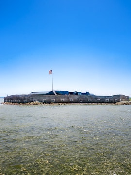 Fort Sumter National Monument viewed from the land-side approach with American flag.
