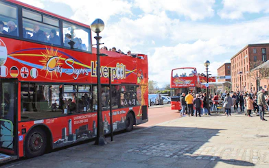 Hop On Hop Off bus in Liverpool waiting for passengers at a city tour stop.