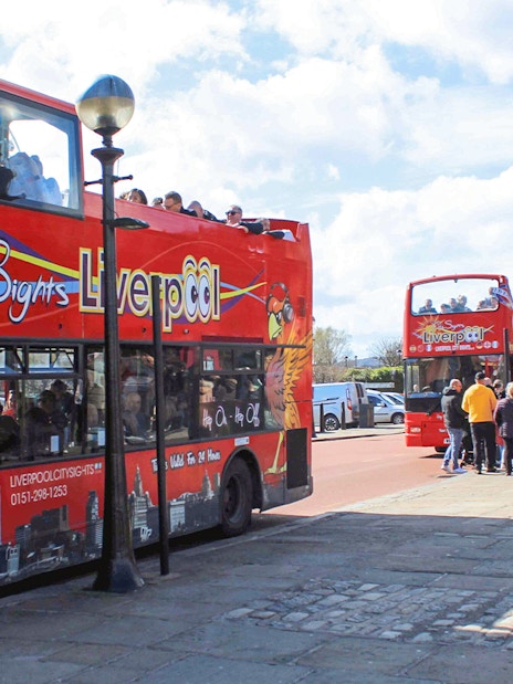Hop On Hop Off bus in Liverpool waiting for passengers at a city tour stop.