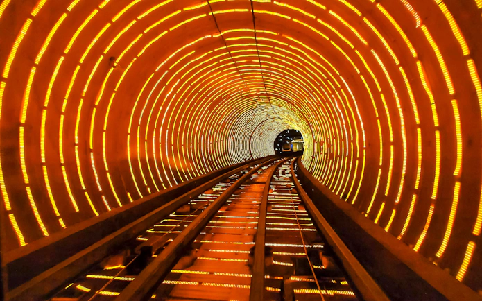 Bund Sightseeing Tunnel in Shanghai with illuminated tracks and vibrant lights.