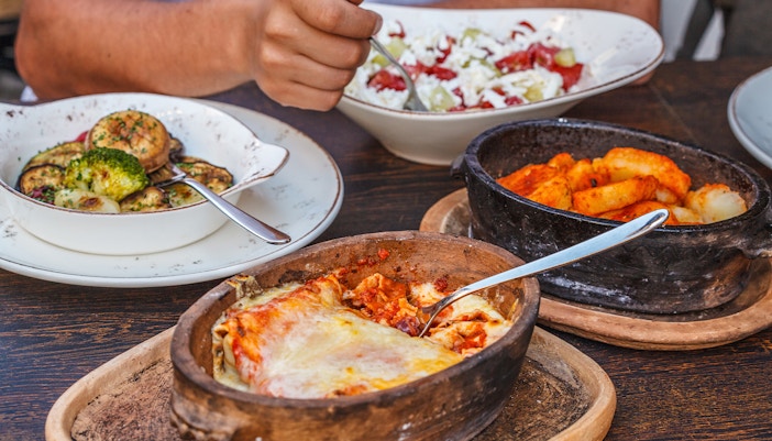Salty pancakes with meat and cheese in a cast-iron pot