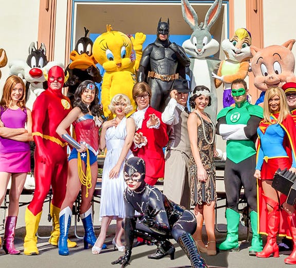 Characters in costume at Warner Bros. Movie World entrance.