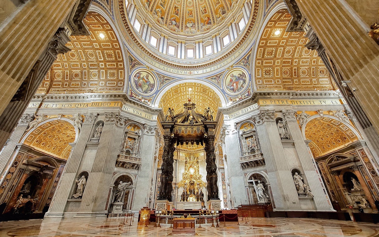 St. Peter’s Basilica interior with ornate dome and Bernini's Baldachin, Vatican City.