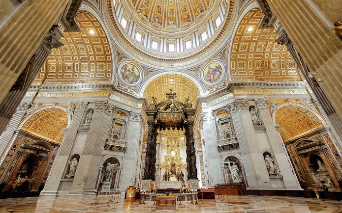 St. Peter’s Basilica interior with ornate dome and Bernini's Baldachin, Vatican City.