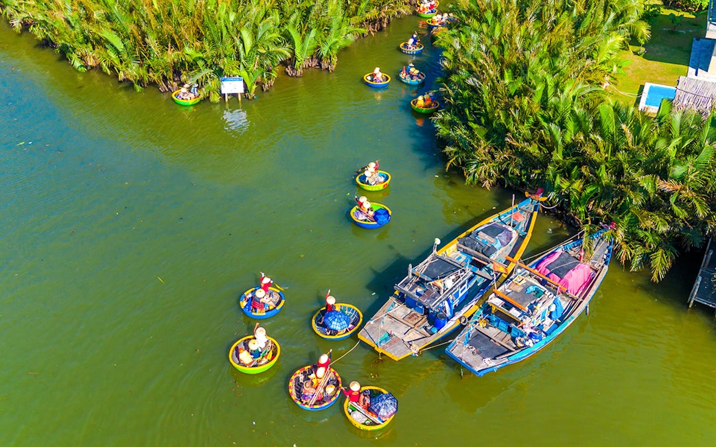 Aerial view of tourists in basket boats on a coconut village tour in Vietnam.