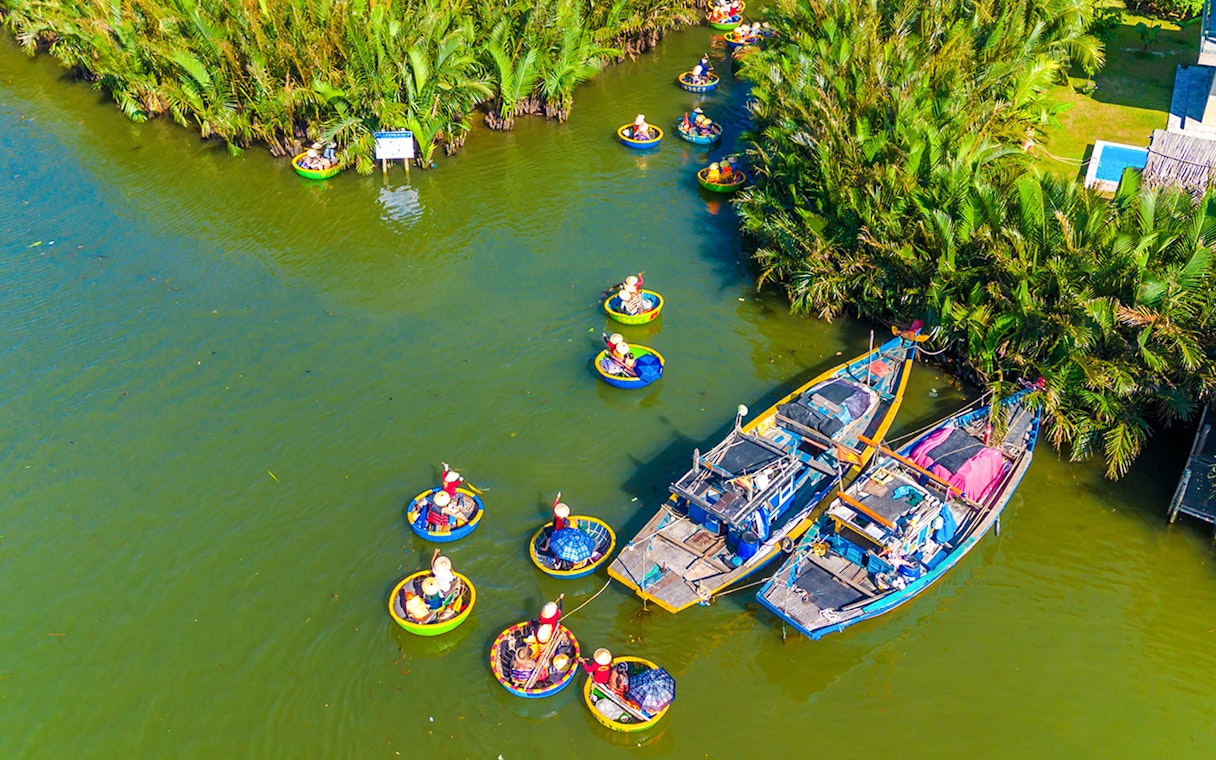 Aerial view of tourists in basket boats on a coconut village tour in Vietnam.