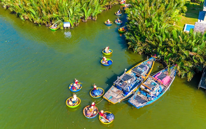 Aerial view of tourists in basket boats on a coconut village tour in Vietnam.