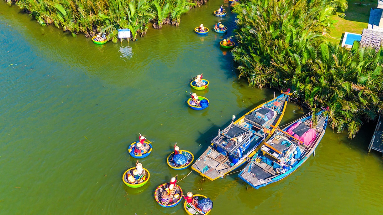 Aerial view of tourists in basket boats on a coconut village tour in Vietnam.
