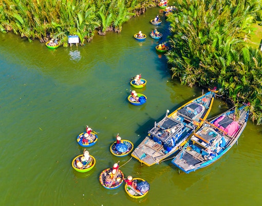 Aerial view of tourists in basket boats on a coconut village tour in Vietnam.