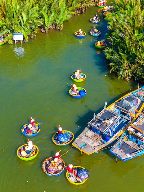 Aerial view of tourists in basket boats on a coconut village tour in Vietnam.