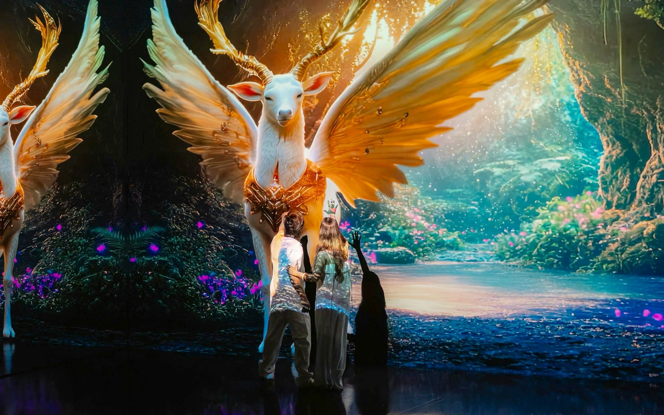 Visitors interacting with digital art of a mythical creature at MAYA Media Art Museum, Phuket.