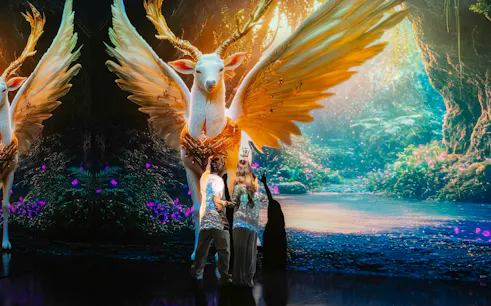 Visitors interacting with digital art of a mythical creature at MAYA Media Art Museum, Phuket.