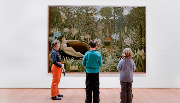 New York Museum of Modern Art interior with visitors viewing contemporary exhibits.