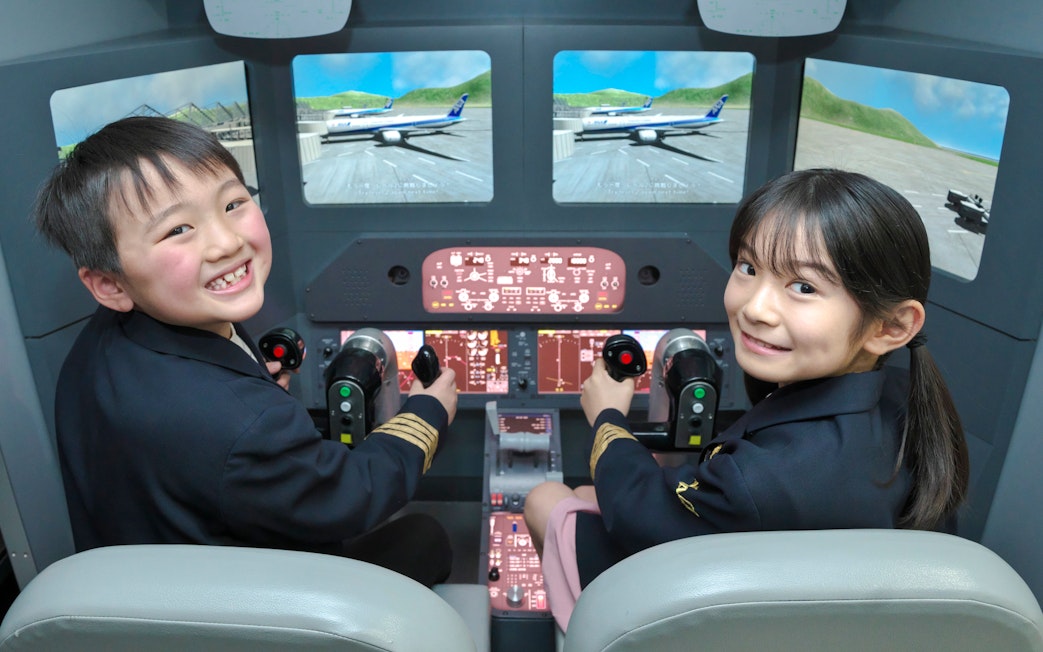 Young pilots in a flight simulator at Kidzania Tokyo.